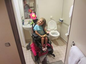 Claire modeling the grab bars around the toilet and roll under sink.